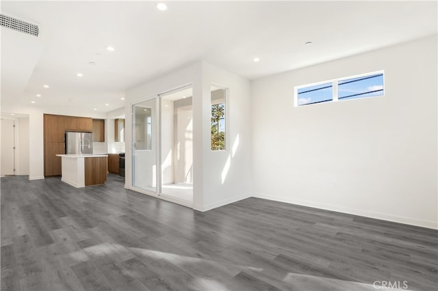 unfurnished living room featuring dark hardwood / wood-style flooring