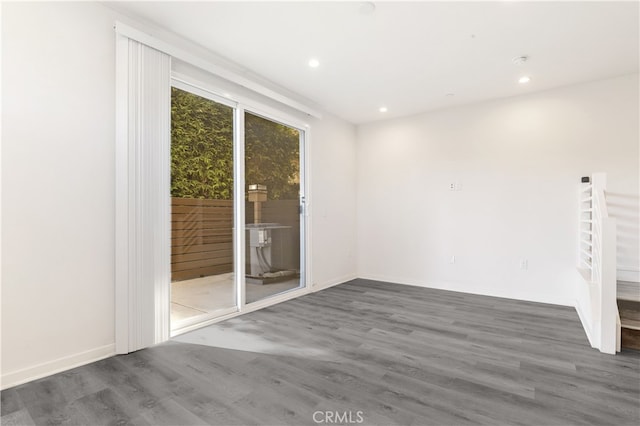 spare room featuring dark hardwood / wood-style flooring