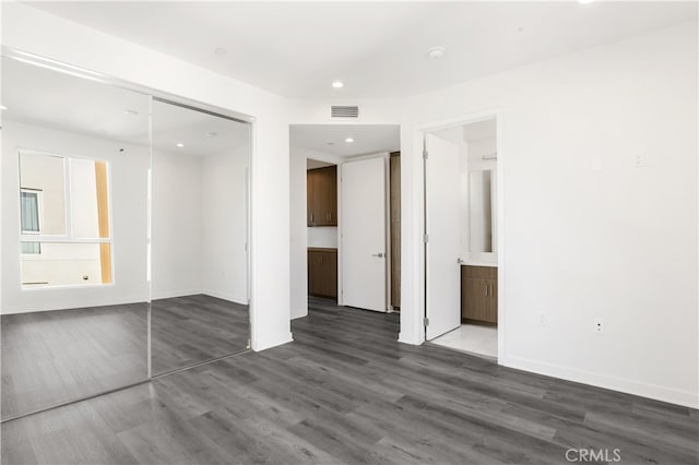 spare room featuring dark wood-type flooring