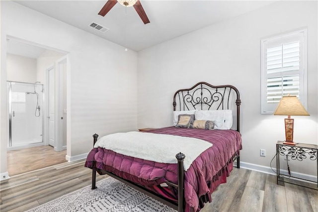 bedroom with ceiling fan, wood finished floors, visible vents, and baseboards