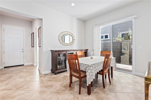 dining room with light tile patterned floors, baseboards, and recessed lighting