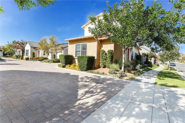 exterior space with a residential view and stucco siding