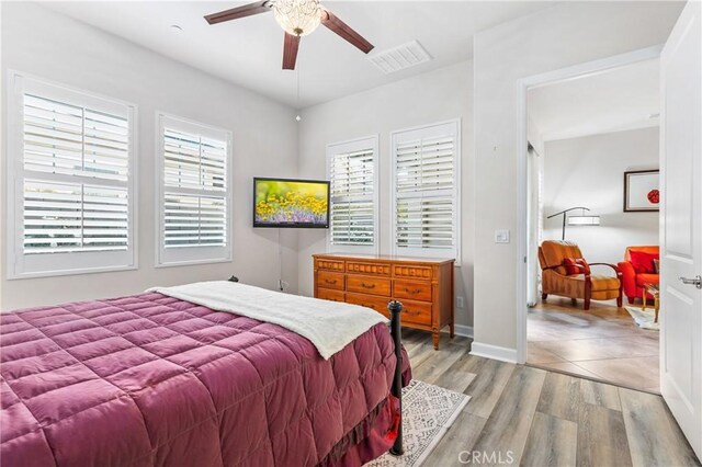 bedroom with ceiling fan and light wood-type flooring