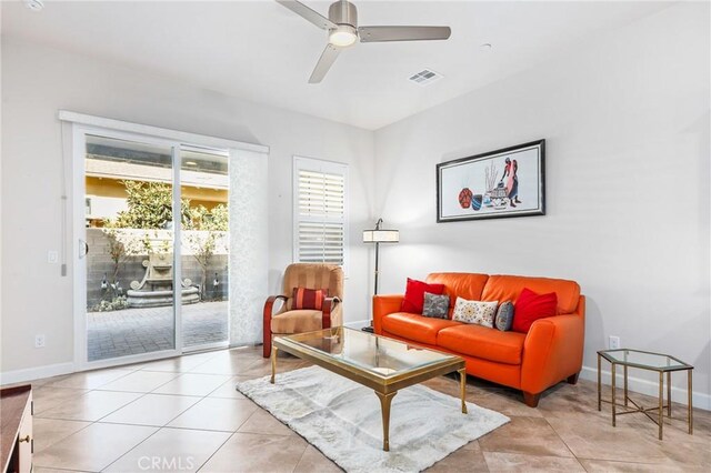 tiled living room featuring ceiling fan