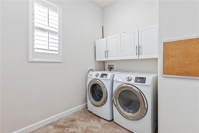 clothes washing area with cabinet space, light tile patterned floors, baseboards, and washing machine and clothes dryer