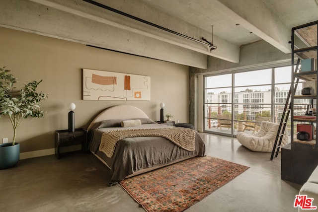 bedroom featuring concrete floors and access to outside