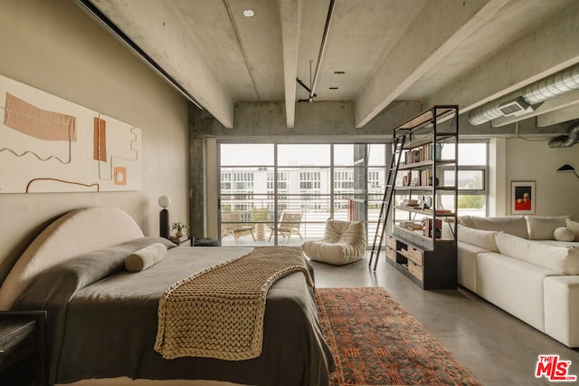 bedroom featuring concrete flooring and multiple windows