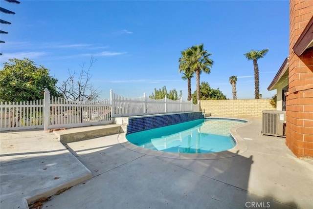 view of swimming pool with central AC and a patio