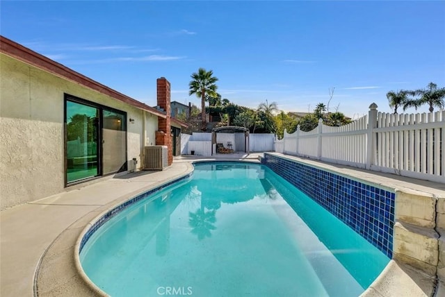 view of pool with a fenced in pool, central air condition unit, and a fenced backyard
