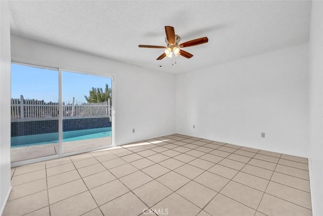 unfurnished room featuring ceiling fan and light tile patterned floors