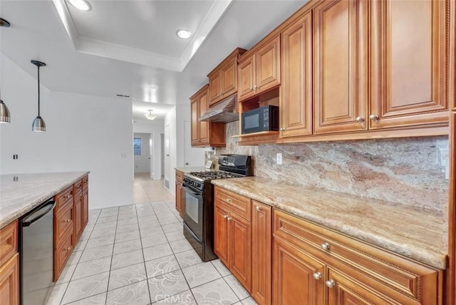 kitchen featuring black appliances, decorative light fixtures, decorative backsplash, a raised ceiling, and light stone counters