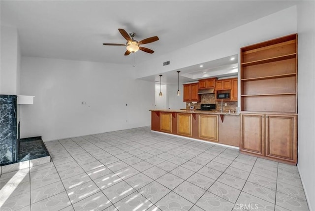 kitchen featuring stove, decorative light fixtures, kitchen peninsula, backsplash, and ceiling fan