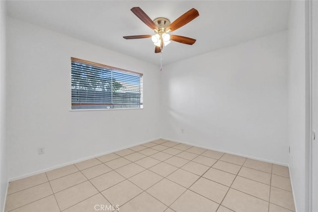 tiled empty room featuring ceiling fan