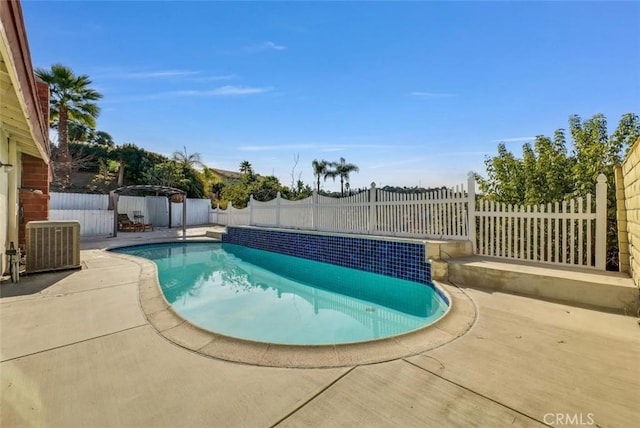 view of swimming pool with a patio, a fenced backyard, central AC, and a fenced in pool