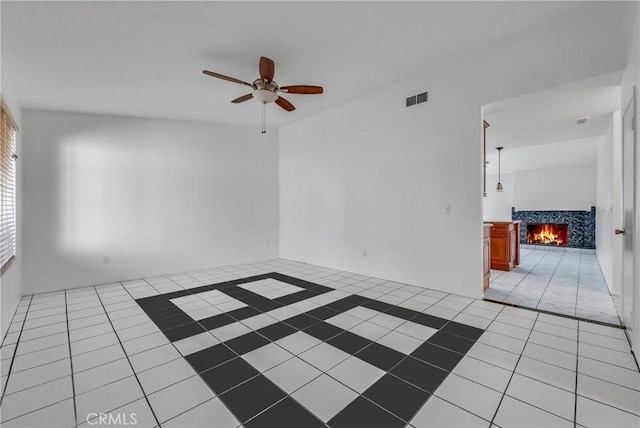 empty room featuring ceiling fan and light tile patterned floors