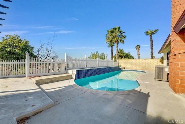 view of swimming pool with a patio, central AC, a fenced in pool, and a fenced backyard