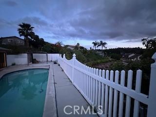 view of swimming pool with fence and a fenced in pool