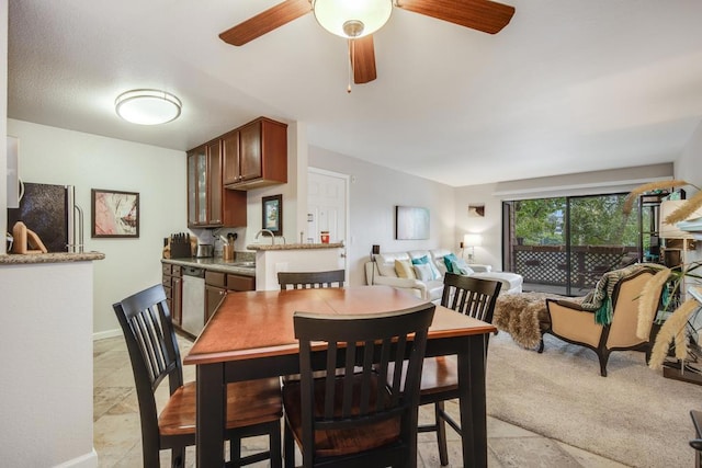 dining room featuring sink and ceiling fan