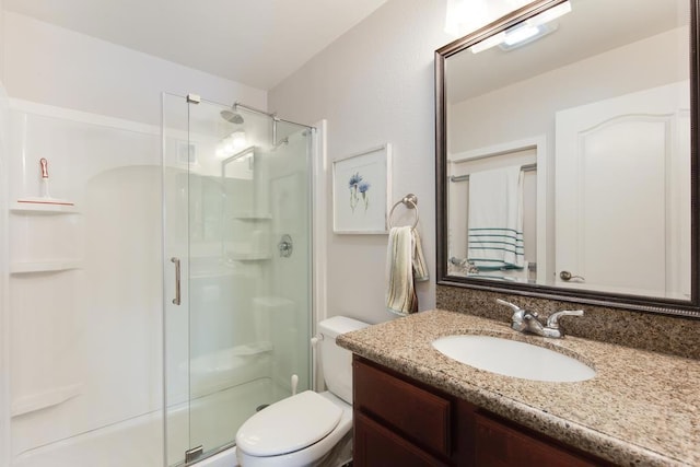 bathroom with vanity, toilet, and walk in shower