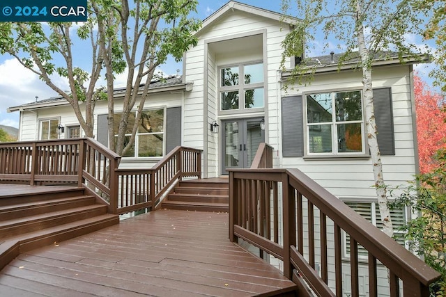 back of house featuring french doors and a wooden deck