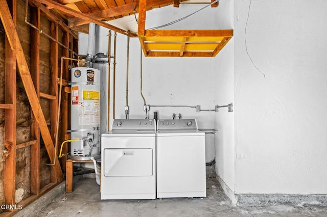 clothes washing area featuring washer and dryer and water heater