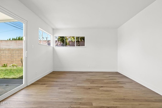 unfurnished room with hardwood / wood-style flooring