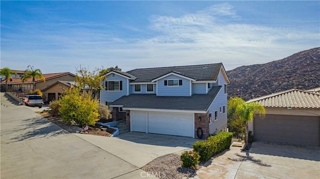 front of property with a mountain view and a garage