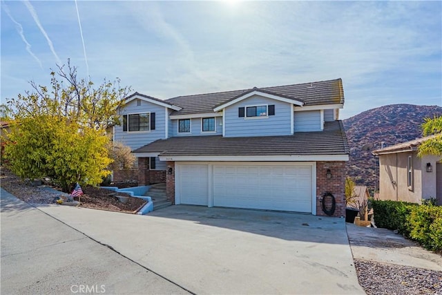 front of property with a mountain view and a garage