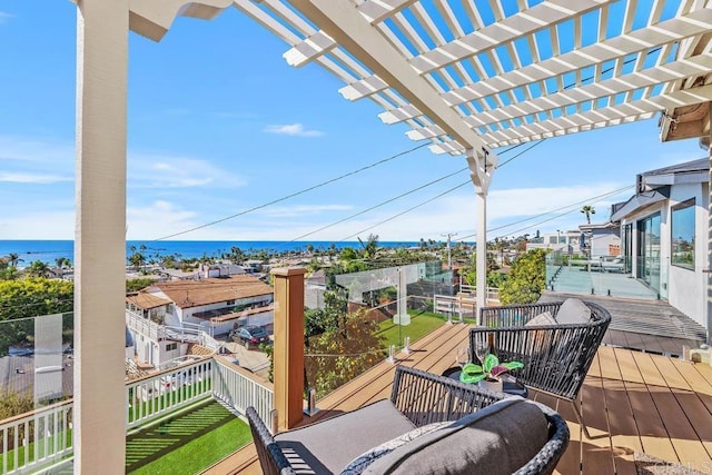 wooden terrace featuring a pergola and a water view