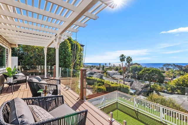 wooden deck with a pergola and a water view