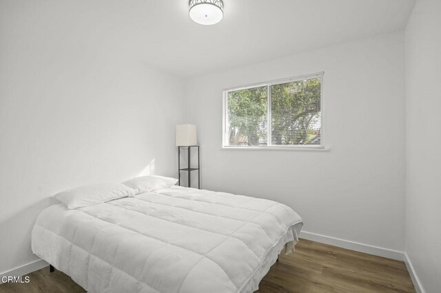 bedroom featuring dark hardwood / wood-style flooring