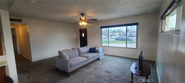 carpeted living room featuring a textured ceiling and ceiling fan