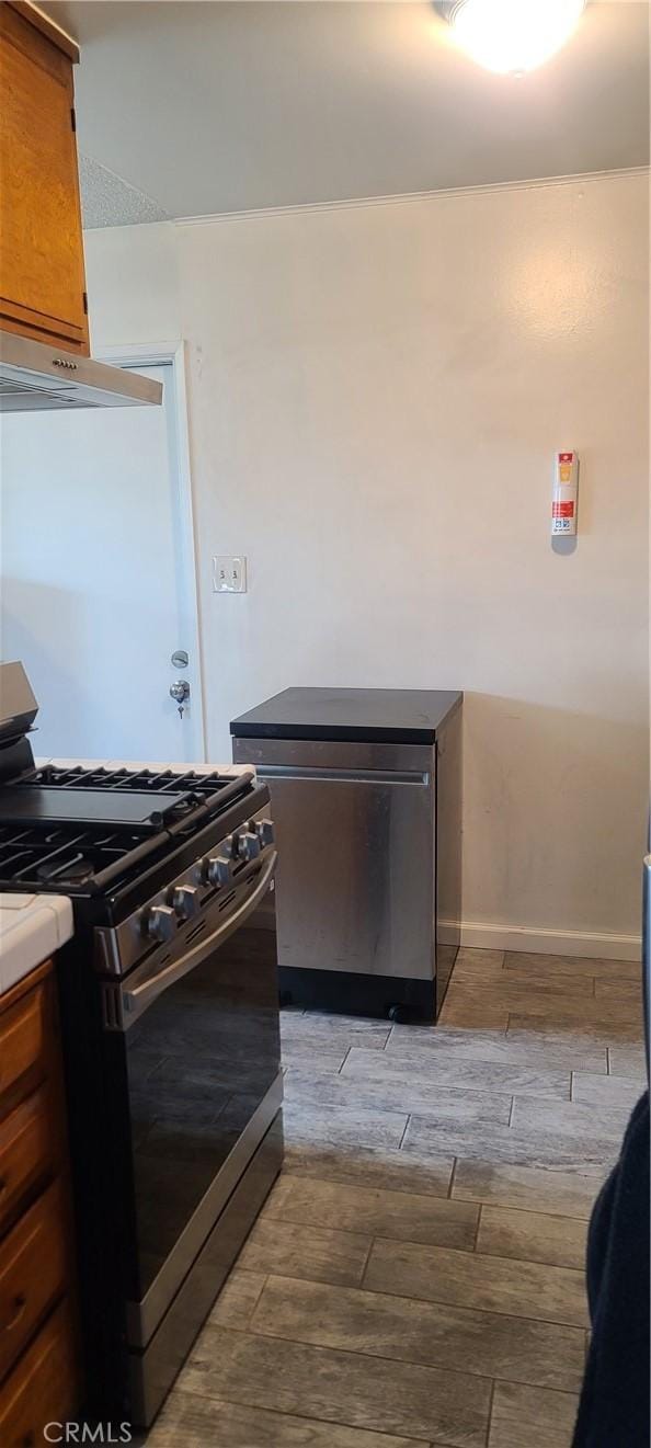 kitchen featuring fridge, gas stove, and light hardwood / wood-style floors