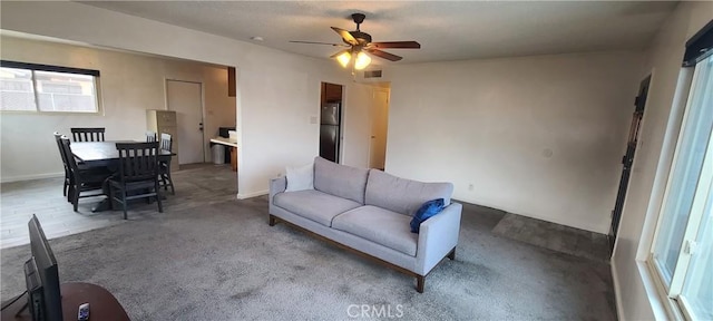 living room with ceiling fan and plenty of natural light