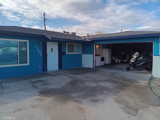 view of front of home with washer / clothes dryer and a garage