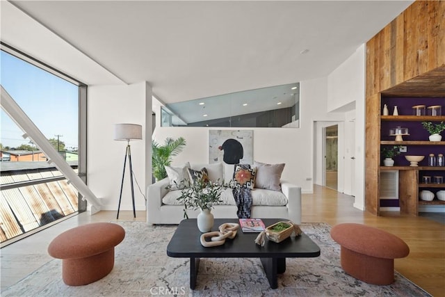 living room featuring vaulted ceiling and light wood-type flooring