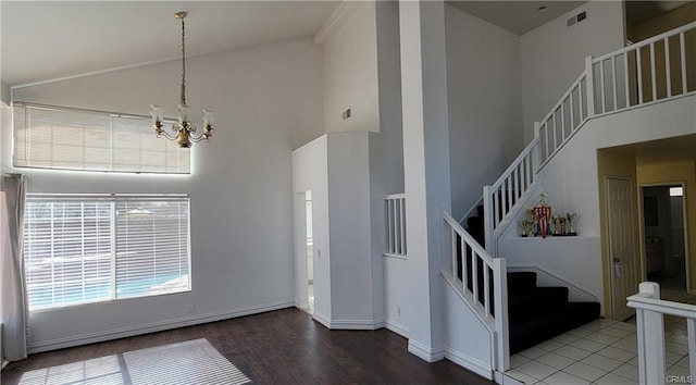 interior space featuring high vaulted ceiling and a notable chandelier