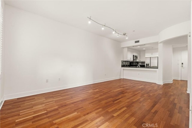 unfurnished living room with wood-type flooring