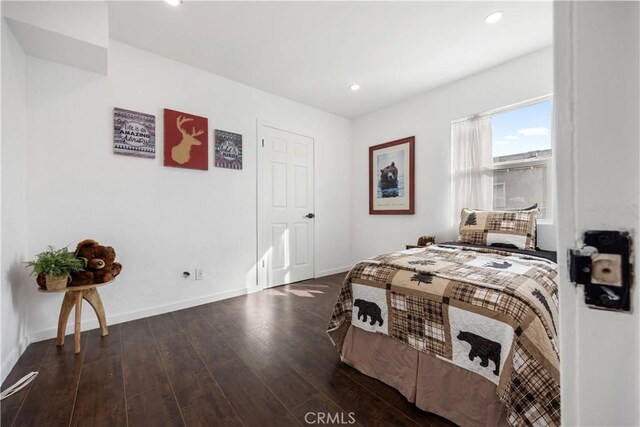 bedroom with dark hardwood / wood-style flooring