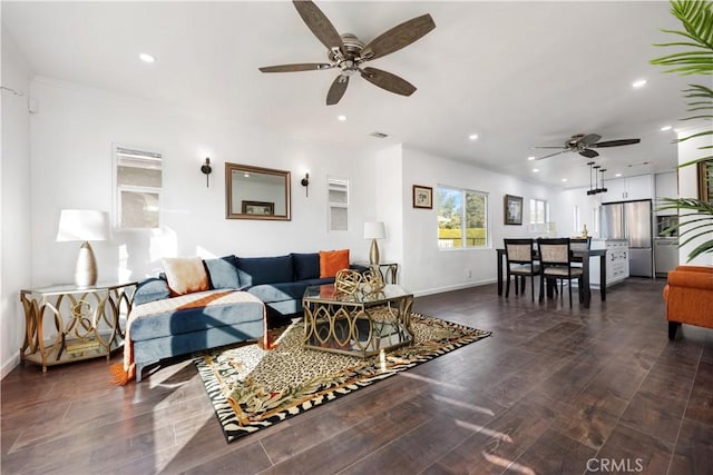 living room featuring dark wood-type flooring and ceiling fan