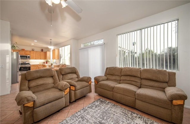 tiled living room with ceiling fan