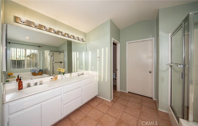 bathroom with tile patterned floors, vanity, vaulted ceiling, and walk in shower