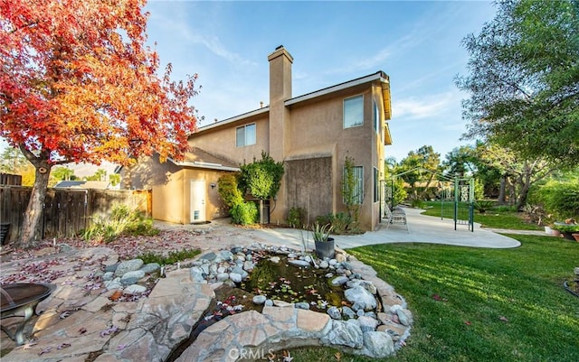 rear view of house with a patio area and a yard