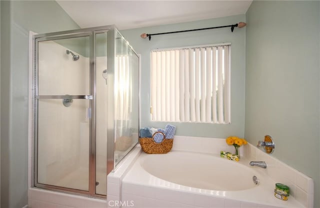 bathroom featuring separate shower and tub