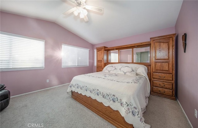 carpeted bedroom with ceiling fan and vaulted ceiling