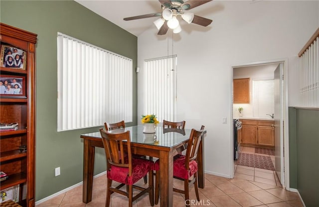 tiled dining room featuring ceiling fan