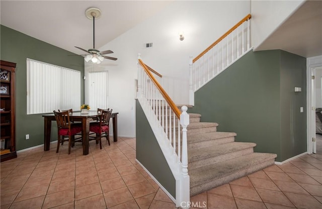 staircase featuring high vaulted ceiling, tile patterned floors, and ceiling fan