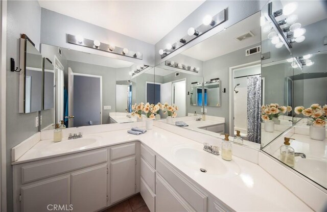 bathroom with vanity, tile patterned floors, and curtained shower