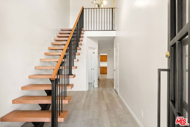 stairway featuring wood-type flooring