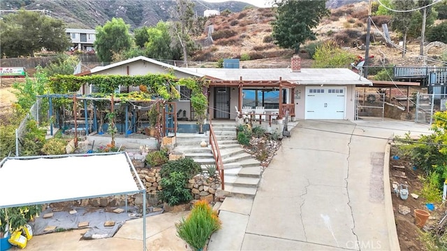 view of front of home with a mountain view and a garage